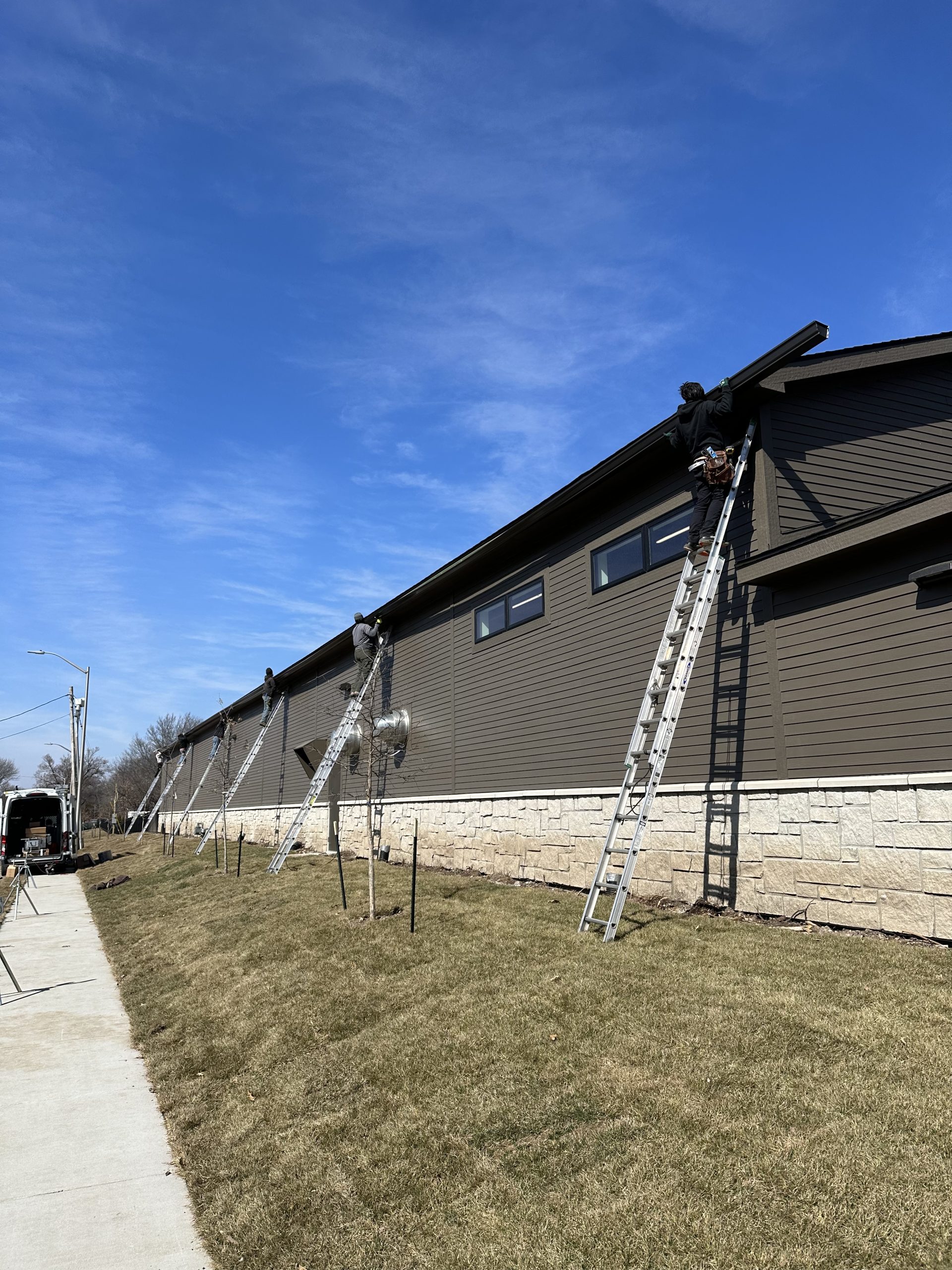 Buck Roofing installing 6" Seamless Gutters at the Milburn Country Club in Overland Park, KS